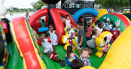 Kids enjoy themselves in a bounce house at The Children's Trust Family Expo.