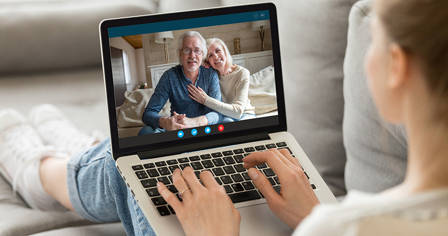 A teenager visits with her grandparents on her tablet.