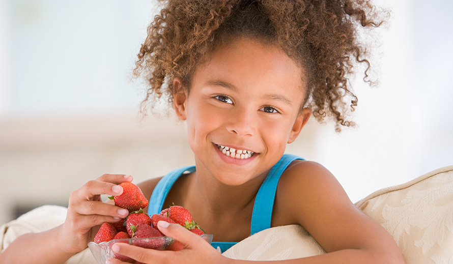 Girl eating strawberries