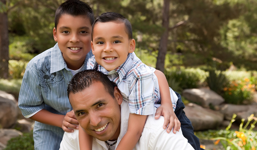 Happy dad and sons outdoors.