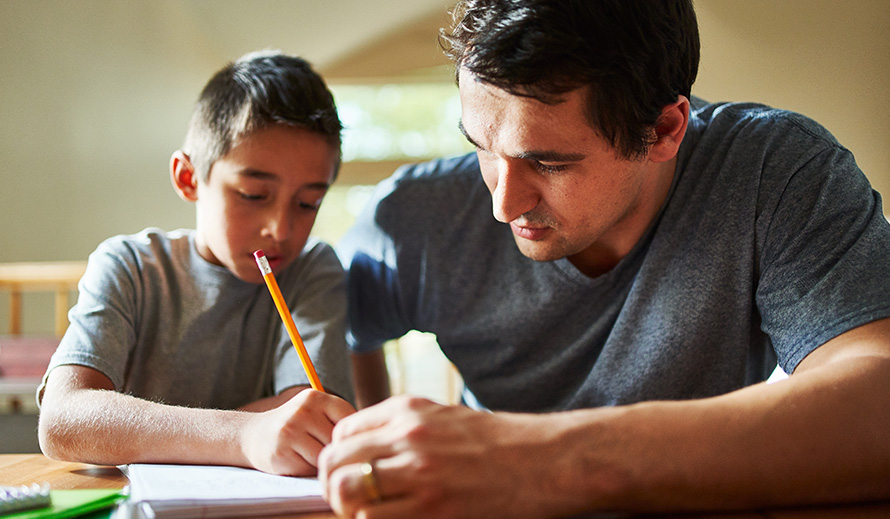 Un padre da tutoría a su hijo.