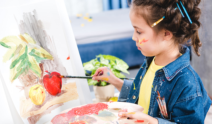 Girl painting an apple