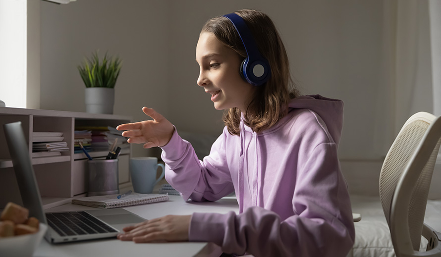 A Hispanic teenager engages in remote learning. 