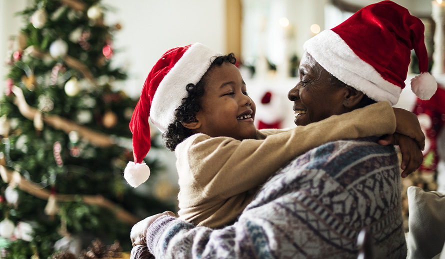 A boy hugs his grandfather during the holidays. 