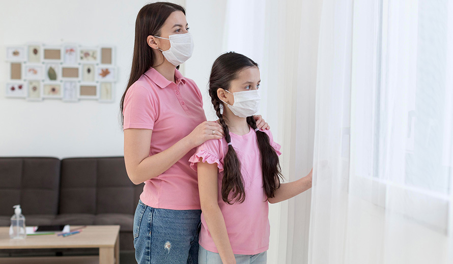 Mother and daughter look outside during the pandemic. 