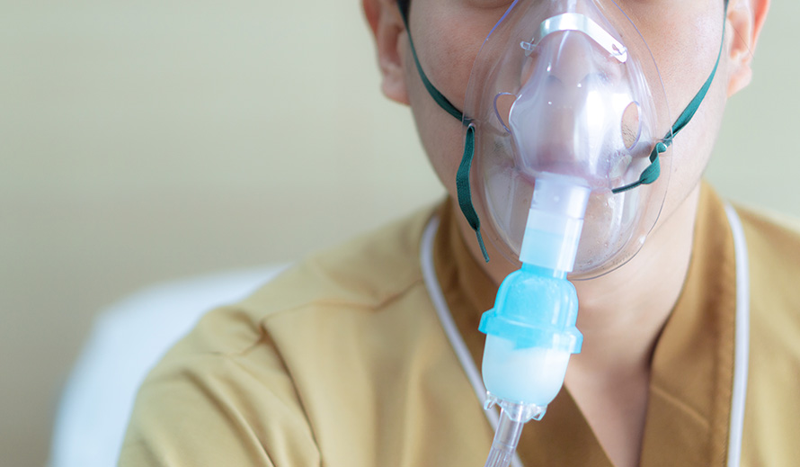 Boy with oxygen mask.