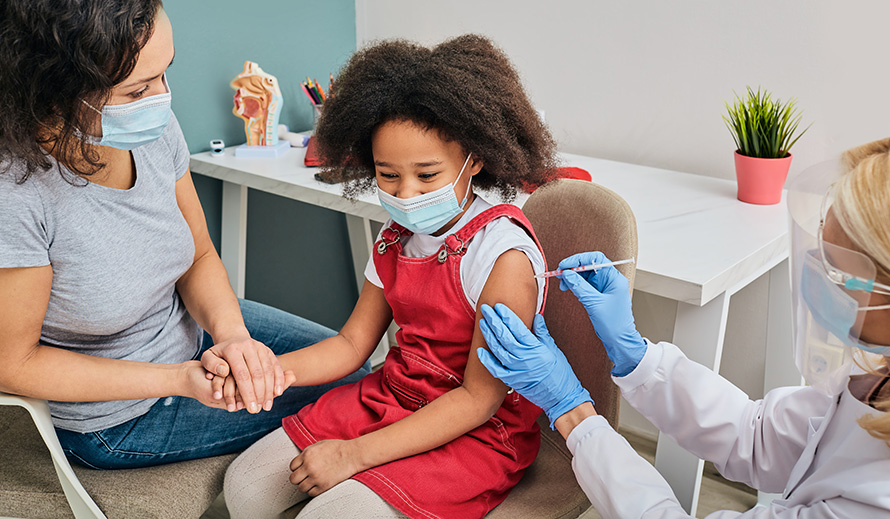 A young girl gets a vaccine shot. 