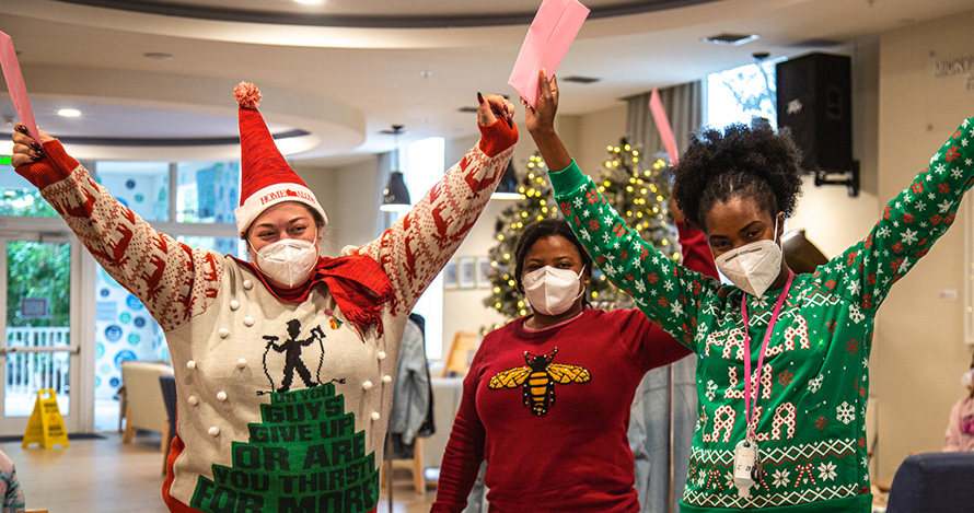 Lotus House employees celebrate with their Help the Helpers gifts. 