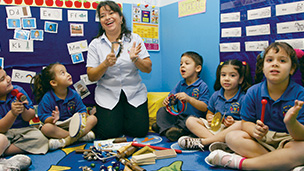 Teacher with kids at childcare center.^