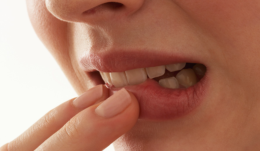 Extreme close-up of a woman biting her lip