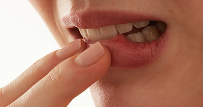 Extreme close-up of a woman biting her lipv