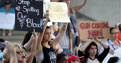 Teens holding signs at gun control rally