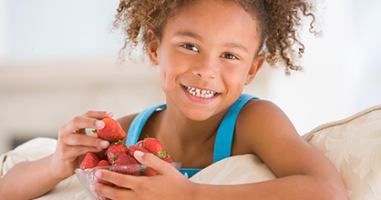 Girl eating strawberries