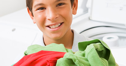 Boy helps with laundry duty