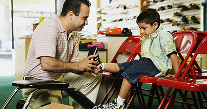 Little boy shopping for shoes