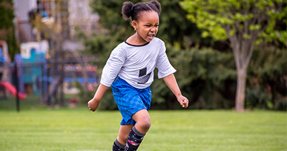 Little girl playing soccer.