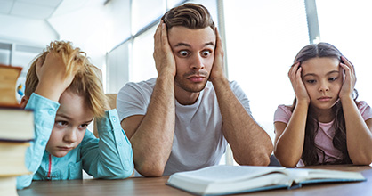 A father and his two kids stress out over homework.