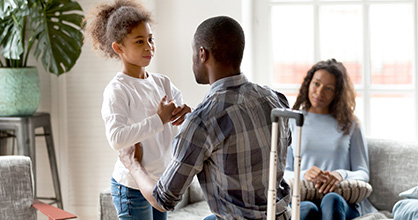 Departing father talks to his daughter while mother looks on.