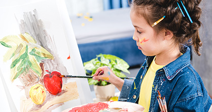 Girl painting an apple